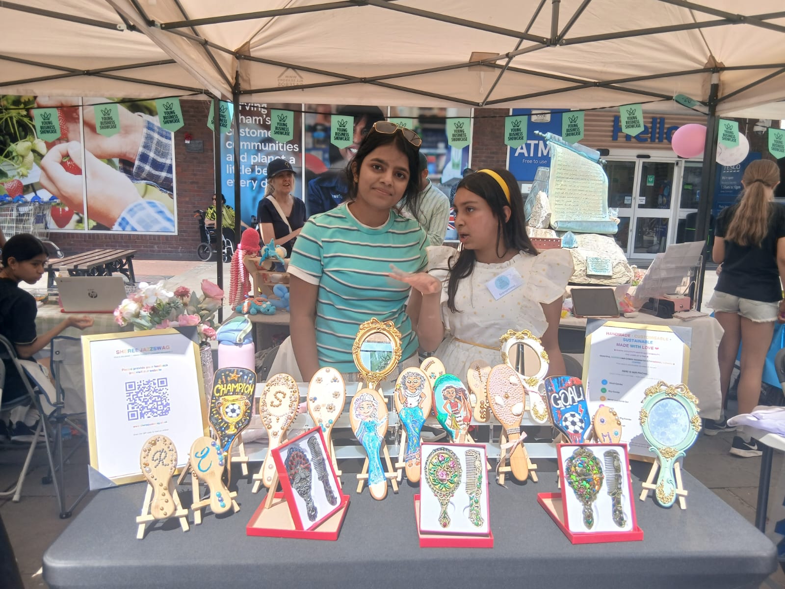 Sheree and friend showing off handmade combs and mirrors at Egham Young Business Showcase